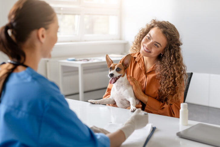 happy-dog-with-owner-vets-office